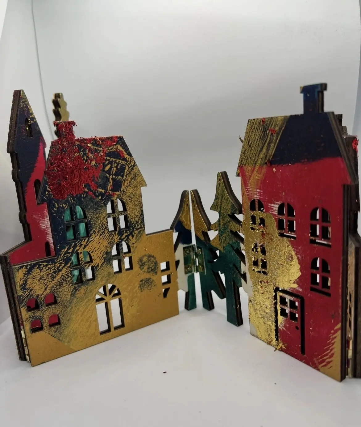 Colourful gelli printed house forms arranged as a small village.