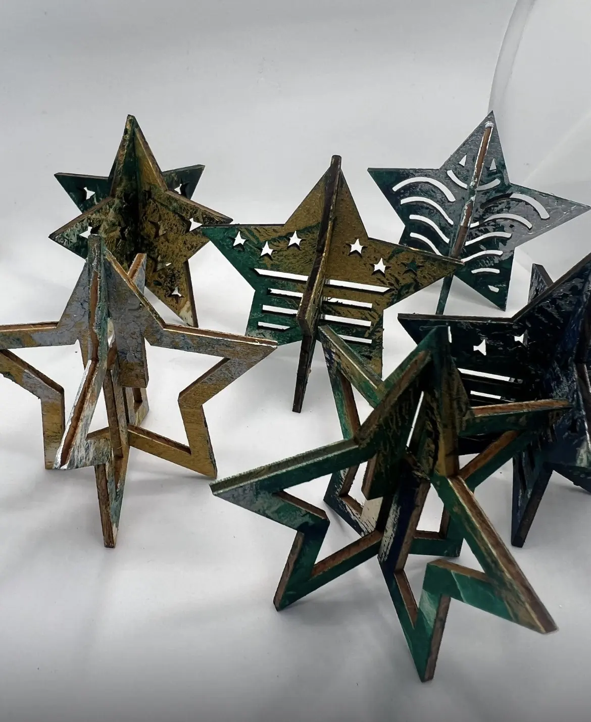 Green, gold and black three-dimensional star ornaments.