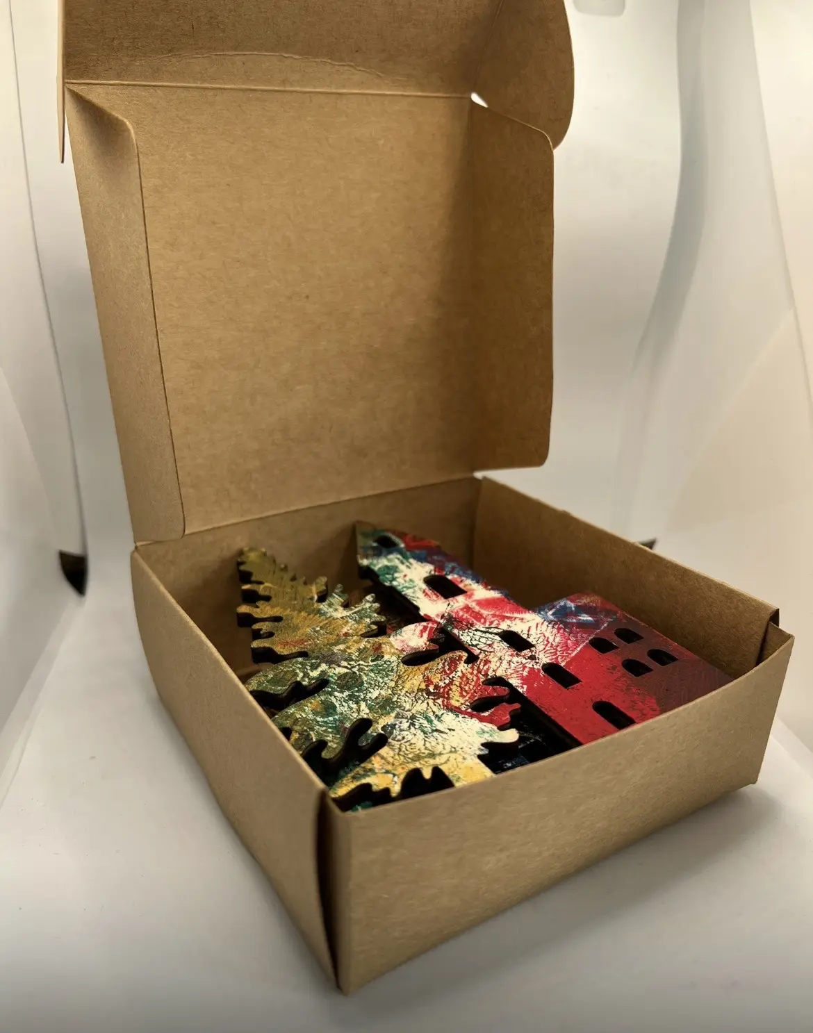 Printed star ornaments presented in a kraft gift box.