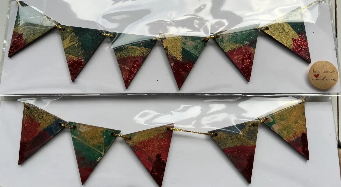 Red, green and gold printed triangular bunting.