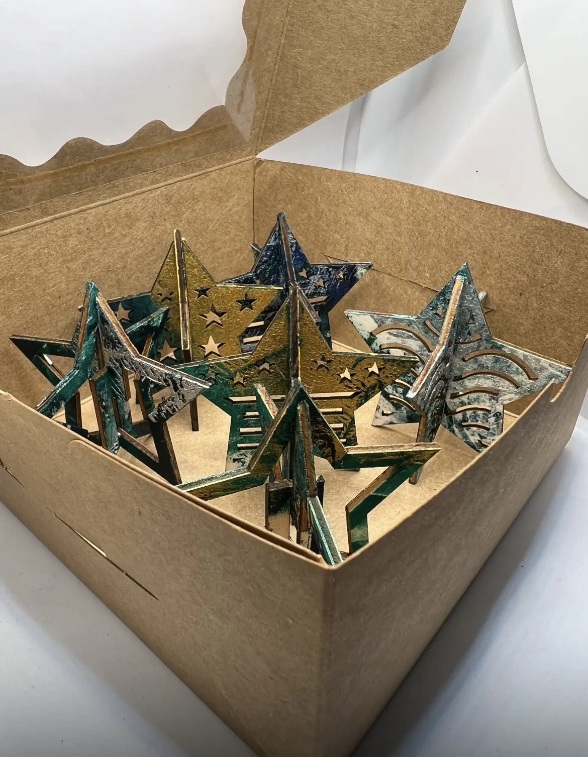 A gift box filled with printed star decorations.