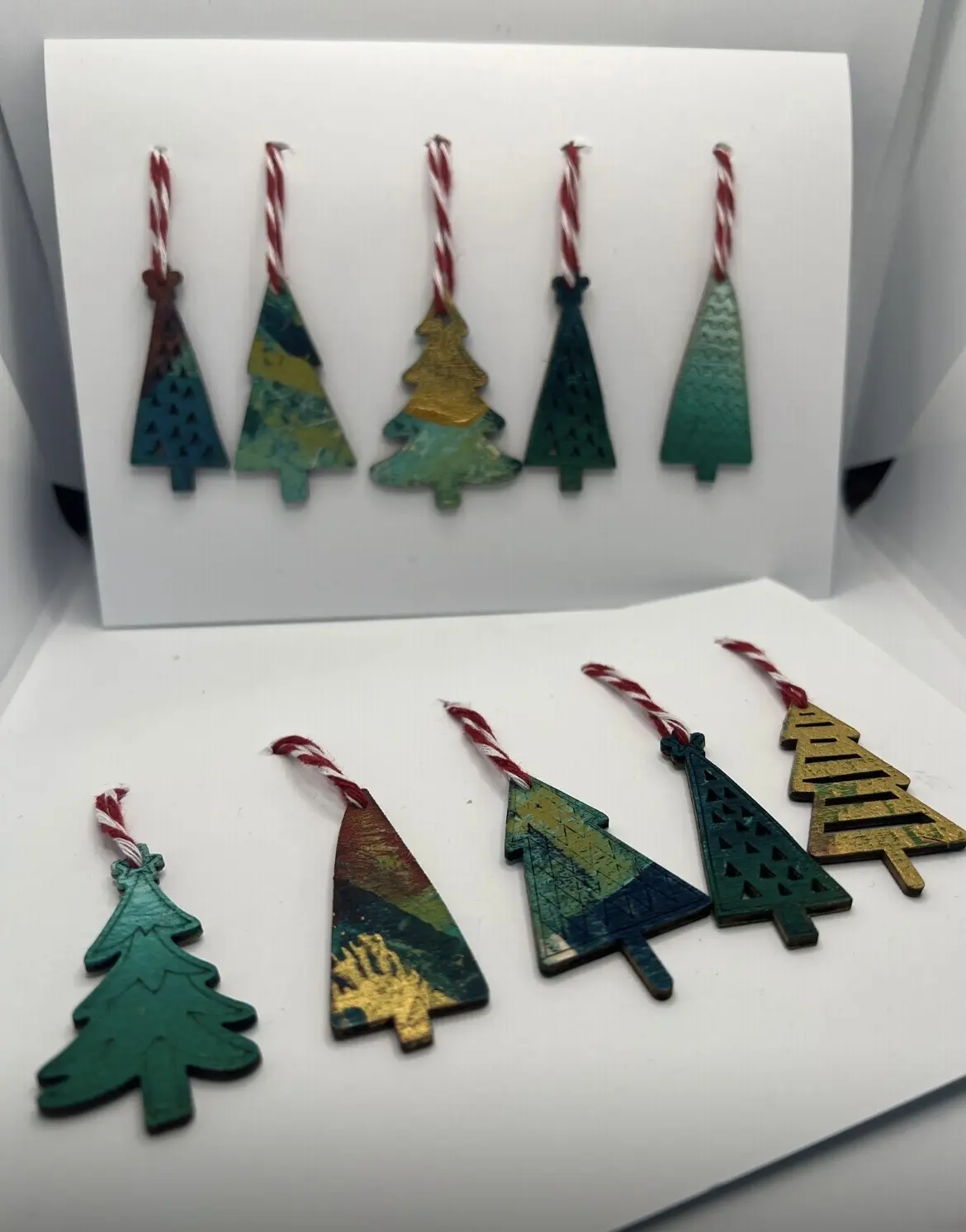 Colourful hanging Christmas tree ornaments arranged as a set.