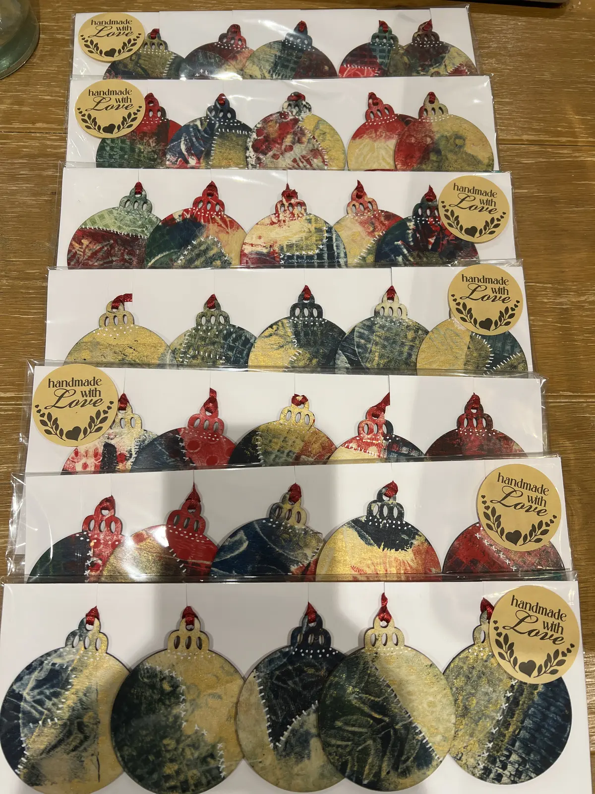 Assorted handmade ornaments in gift packaging.