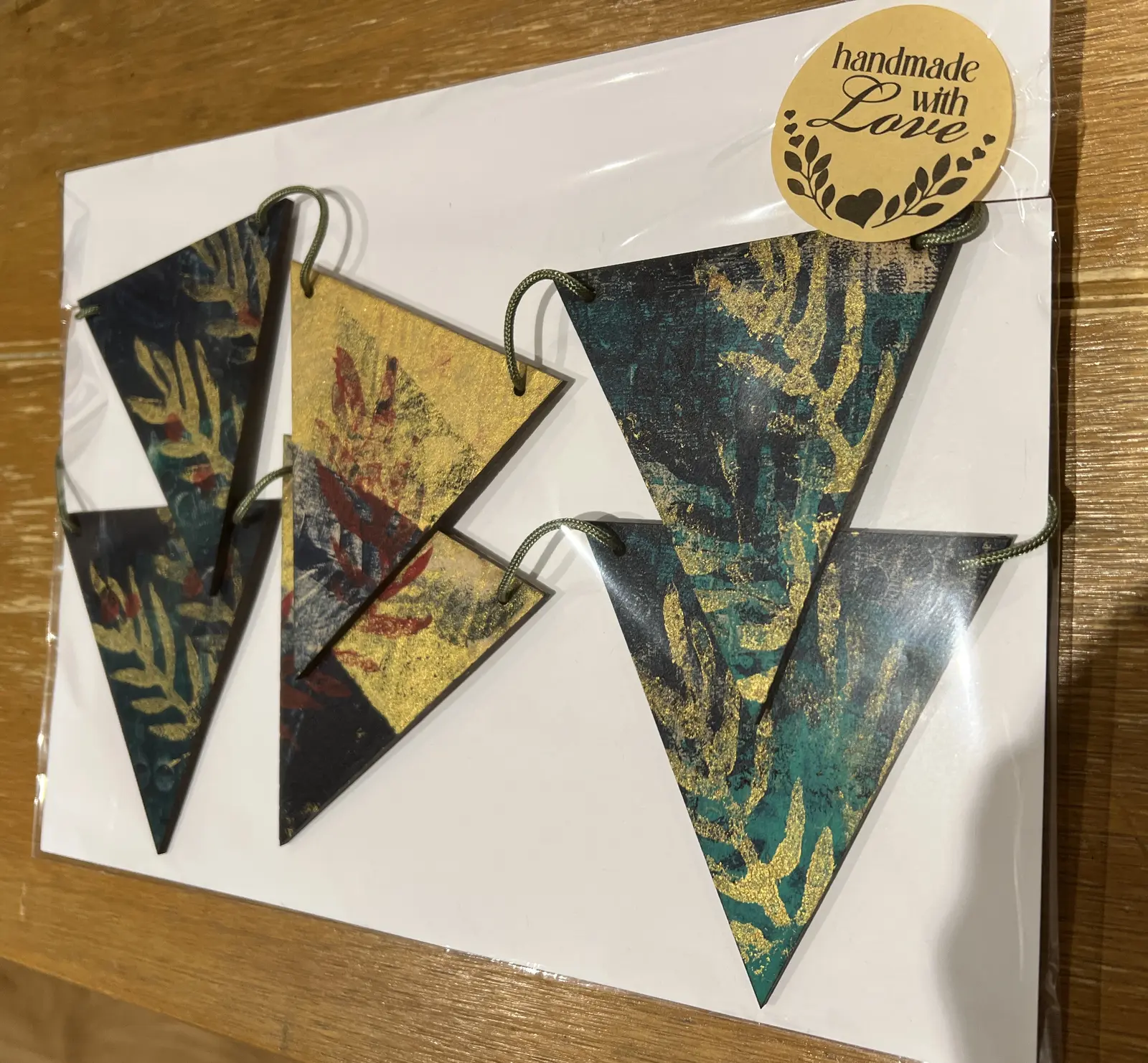 Packaged set of teal, red and gold printed bunting.